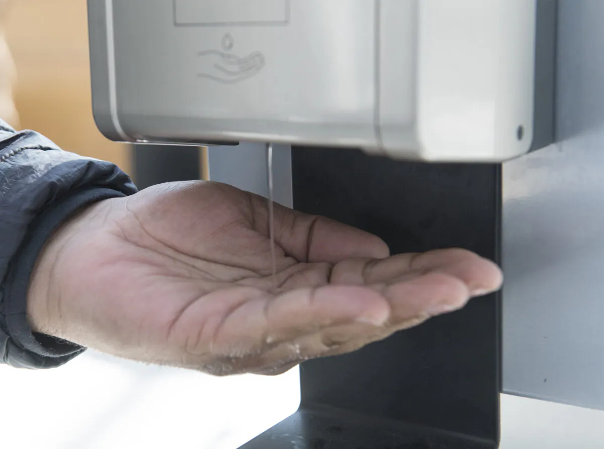 A man dispenses hand sanitizer in a shopping mall in the Montreal borough of Pointe-Claire, Canada, on March 14, 2020. (Graham Hughes/The Canadian Press)