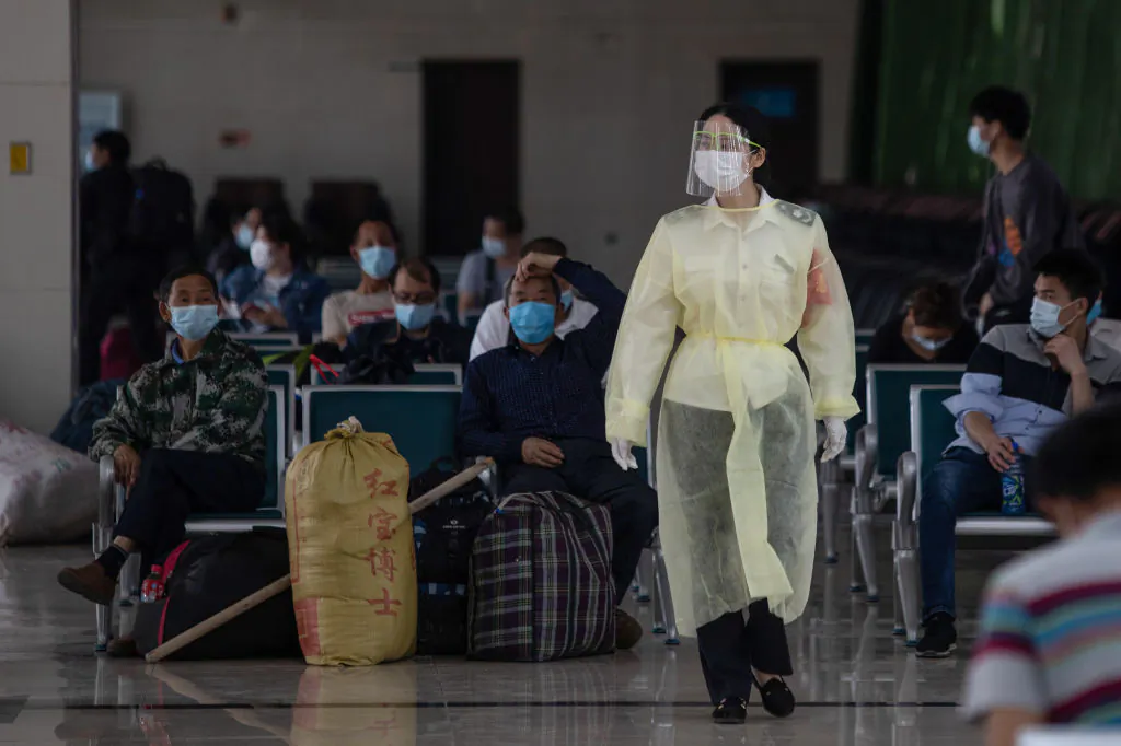 A staff member wearing a face shield walks through a bus station in Wuhan in central China's Hubei province on April 30, 2020. (STR/AFP via Getty Images)