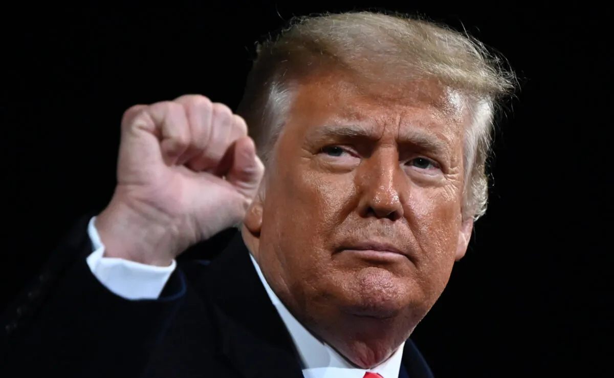 President Donald Trump raises his fist at the end of a rally to support Republican Senate candidates at Valdosta Regional Airport in Valdosta, Ga., on Dec. 5, 2020. (Andrew Caballero-Reynolds /AFP via Getty Images)