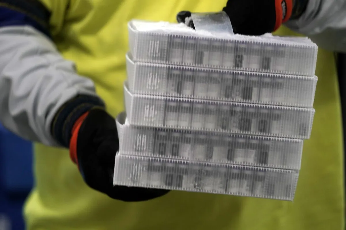 Boxes containing the Pfizer-BioNTech COVID-19 vaccine are prepared to be shipped at the Pfizer Global Supply Kalamazoo manufacturing plant in Portage, Mich., on Dec. 13, 2020. (Morry Gash/Pool/AP Photo)