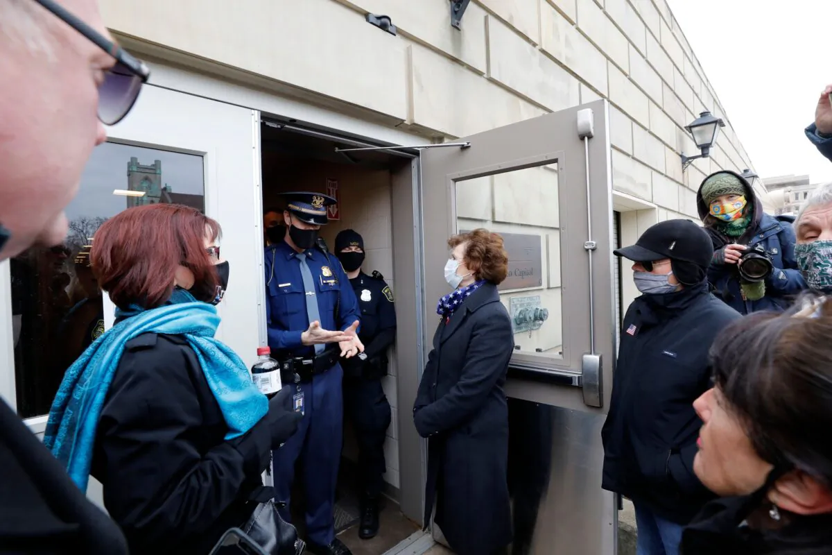 Electors from the GOP are denied entry to the Michigan Capital as the Electors from the Democratic Party cast their ballot in Lansing, Mich., on Dec. 14, 2020. (Jeff Kowalsky/AFP via Getty Images)