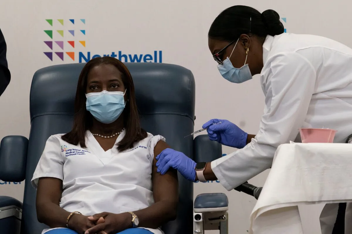Sandra Lindsay, a nurse at Long Island Jewish Medical Center, is inoculated with the COVID-19 vaccine from Pfizer and BioNTech, at Long Island Jewish Medical Center in New Hyde Park, N.Y., on Dec. 14, 2020. (Mark Lennihan/Pool via Reuters)