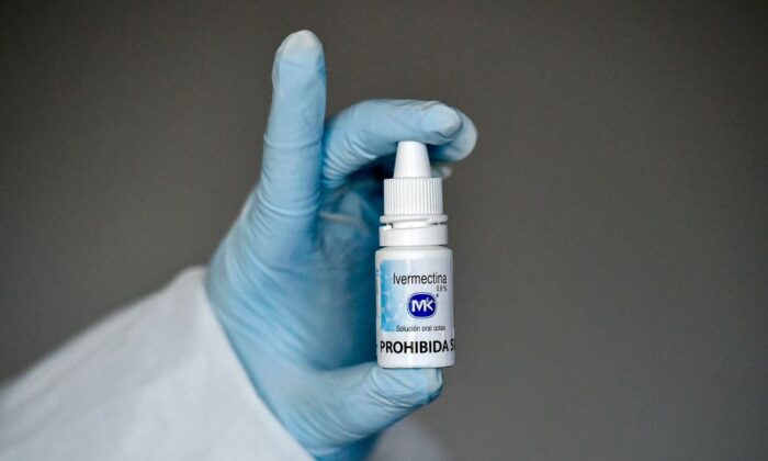 A health worker shows a bottle of ivermectin, a medicine authorized by the National Institute for Food and Drug Surveillance to treat patients with mild, asymptomatic or suspicious COVID-19, as part of a study of the Center for Paediatric Infectious Diseases Studies, in Cali, Colombia, on July 21, 2020. (Luis Robayo/AFP via Getty Images)