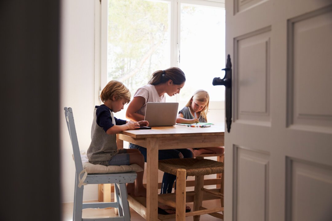 Mom with kids at home. (Yaw Niel/Shutterstock)