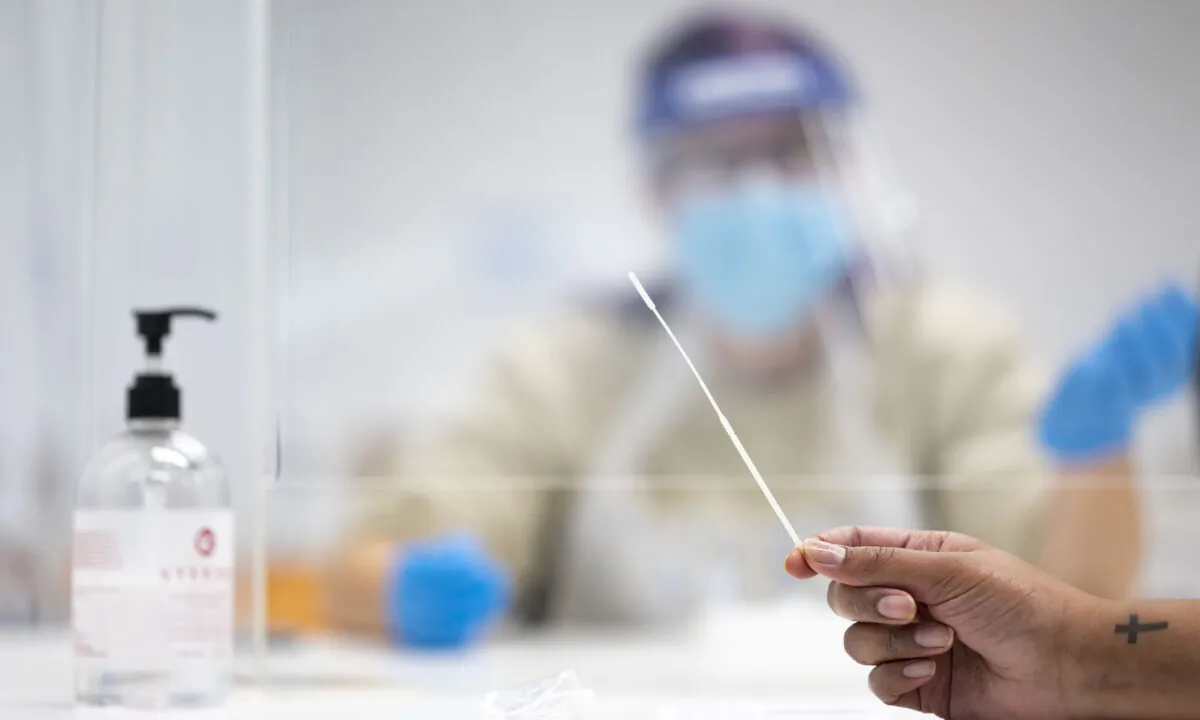 A student holds a swab that is part of a lateral flow test at Swansea University in Swansea, Wales, on Dec. 8, 2020. (Matthew Horwood/Getty Images)