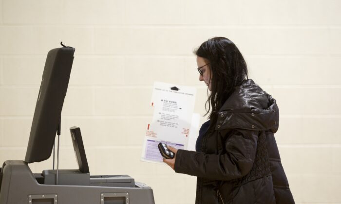 A Michigan voter uses a machine during the presidential primary election in Warren, Mich., on March 10, 2020. (Elaine Cromie/Getty Images)