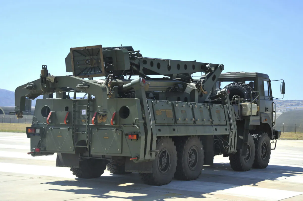 A truck carrying parts of the S-400 air defense systems exits a Russian transport aircraft after landing at Murted military airport outside Ankara, Turkey, on Aug. 27, 2019. (Turkish Defence Ministry via AP, Pool, File)