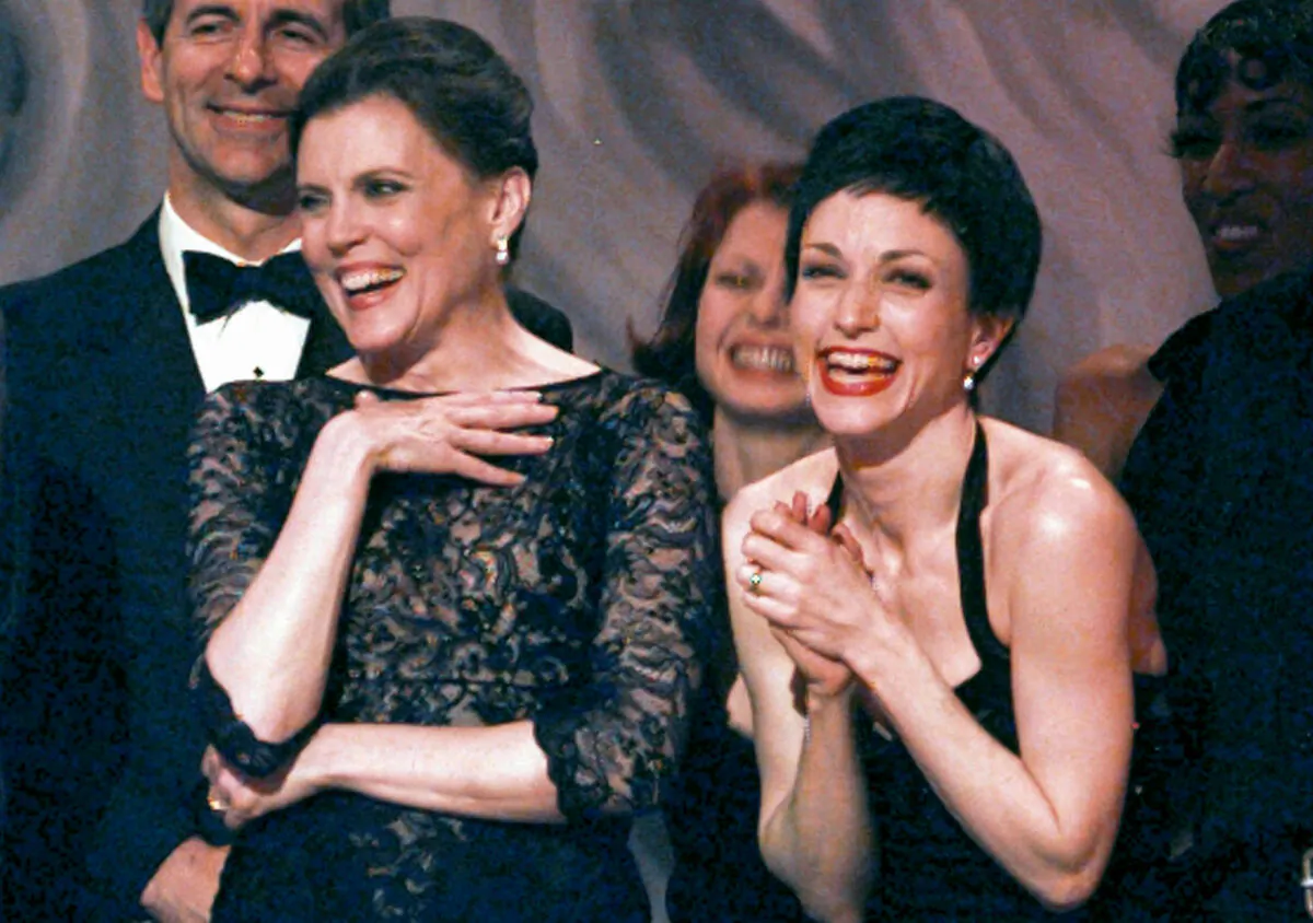 Ann Reinking (L) and Bebe Neuwirth share a laugh on stage while accepting the award for best revival of "Chicago" during the 51st Annual Tony Awards in New York City on June 1, 1997. (Adam Nadel/AP Photo)