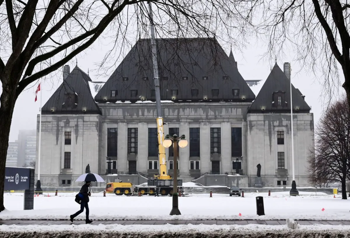 A pedestrian walks past the Supreme Court of Canada in Ottawa on Nov. 26, 2020. (The Canadian Press/Sean Kilpatrick)