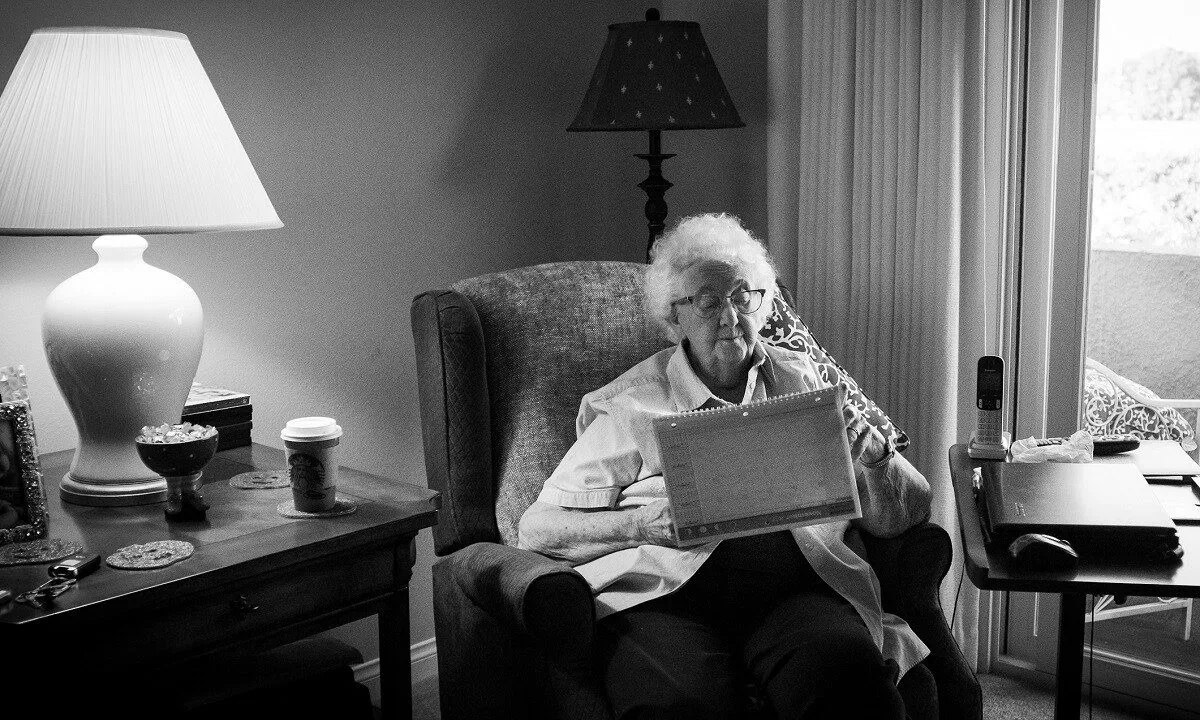 A file photo shows a senior citizen sitting in her room in Freedom Village Retirement Community in Lake Forest, Calif., in 2017. (John Fredricks/The Epoch Times)