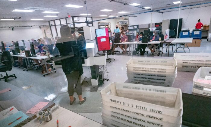 Poll workers count ballots inside the Maricopa County Election Department in Phoenix, Ariz., on Nov. 5, 2020. (Olivier Touron/AFP via Getty Images)