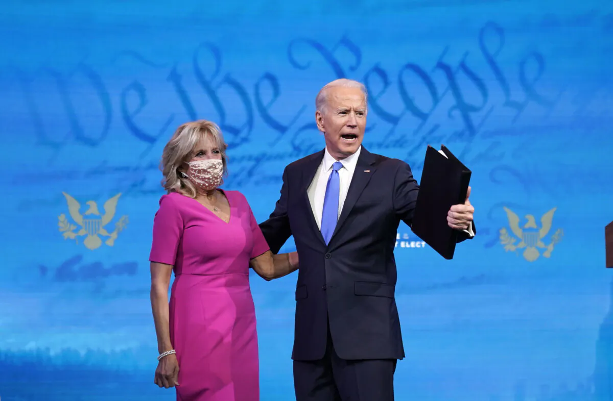 Former Vice President Joe Biden (R) embraces his wife Jill Biden after speaking about the Electoral College vote certification process at The Queen theater in Wilmington, Delaware, on Dec. 14, 2020. (Drew Angerer/Getty Images)