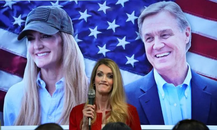Sen. Kelly Loeffler (R-Ga.) speaks in front of a picture of her and Sen. David Perdue (R-Ga.) at a campaign event at the Cobb County Republican Party Headquarters in Marietta, Ga., on Nov. 11, 2020. (Elijah Nouvelage/Reuters)