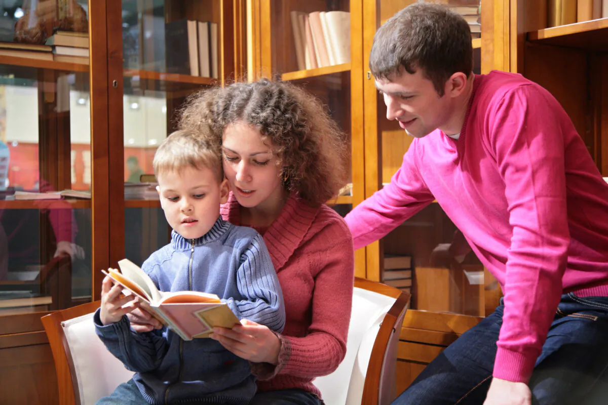 Undated stock photo illustrating parents reading to a child. (Pavel L Photo and Video/Shutterstock)
