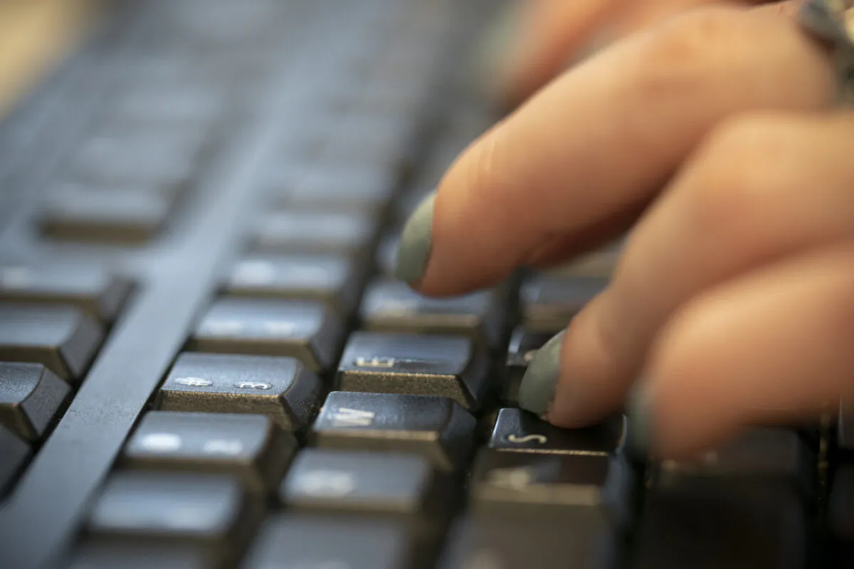 A woman types on a keyboard in New York. (Jenny Kane/AP Photo)
