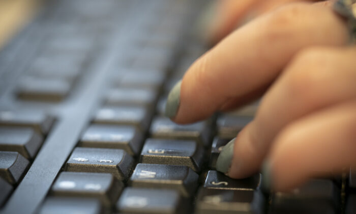 A woman types on a keyboard in New York. (Jenny Kane/AP Photo)