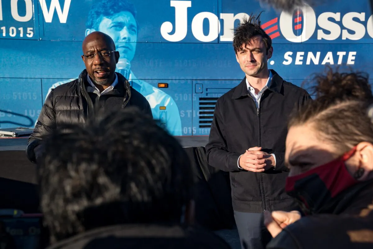 Democratic Georgia Senate candidates Rev. Raphael Warnock (L) and Jon Ossoff address supporters during a rally in Atlanta, Ga., on Dec. 14, 2020. (Megan Varner/Getty Images)