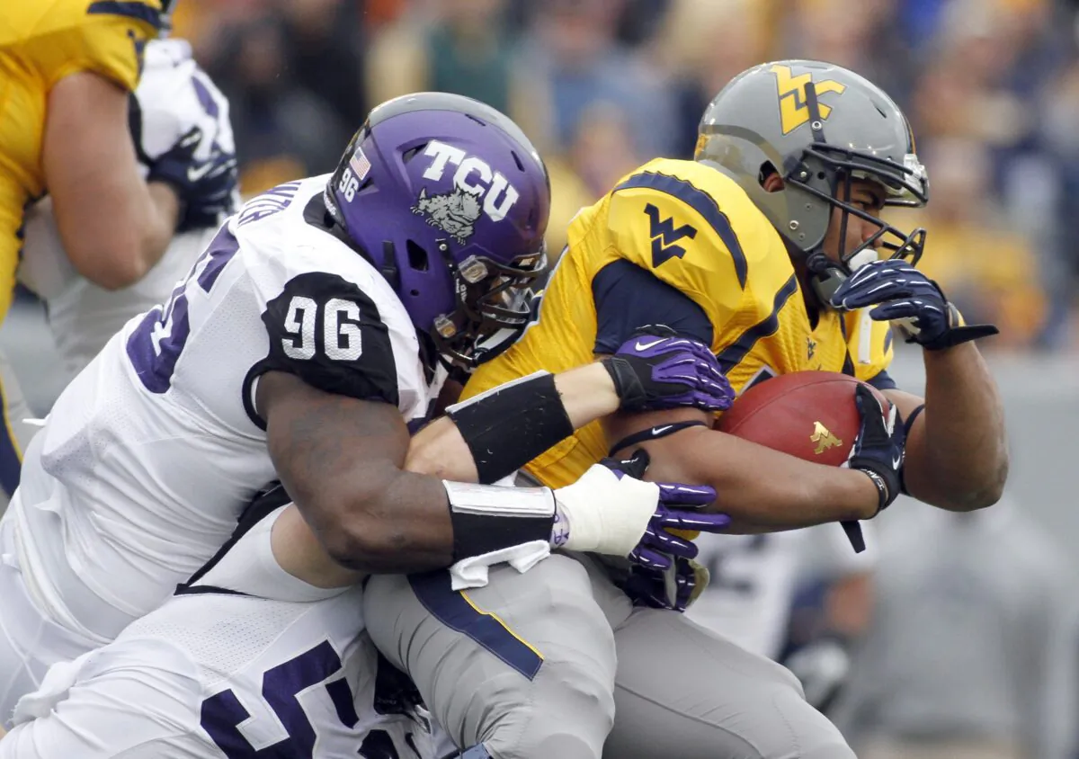Shawne Alston (R) of the West Virginia Mountaineers, is tackled by Chucky Hunter of the TCU Horned Frogs during a game at Mountaineer Field in Morgantown, W.Va., on Nov. 3, 2012.  (Justin K. Aller/Getty Images)