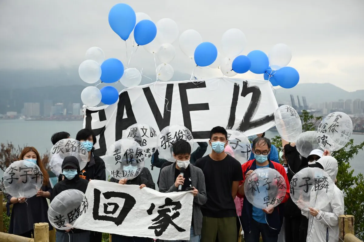 Four families and members of the Save12HKers campaign group prepare to fly balloons towards Yantian in mainland China (back) at Crooked Island in Hong Kong, on Nov. 21, 2020. (Peter Parks/AFP via Getty Images)