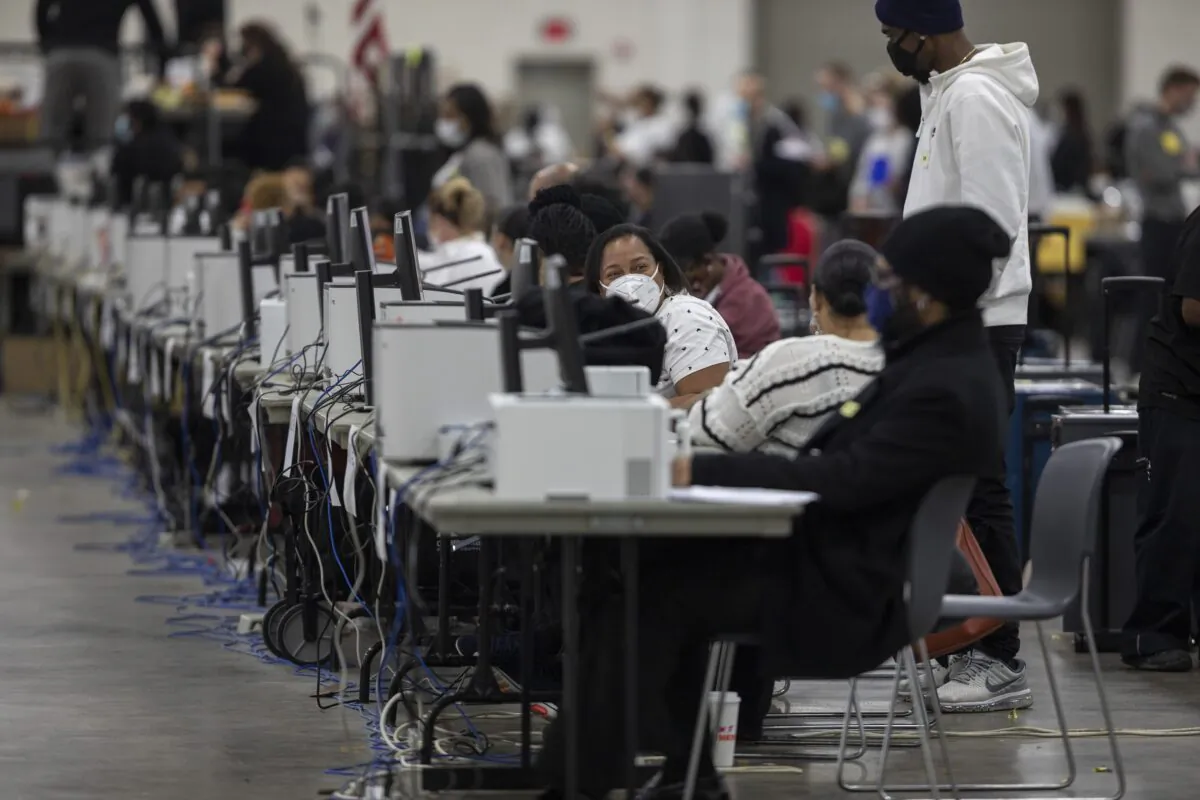 Workers with the Detroit Department of Elections wait to process absentee ballots at the Central Counting Board in the TCF Center in Detroit, Mich., on Nov. 4, 2020. (Elaine Cromie/Getty Images)