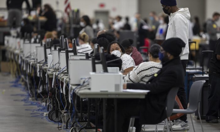 Workers with the Detroit Department of Elections wait to process absentee ballots at the Central Counting Board in the TCF Center in Detroit, Mich., on Nov. 4, 2020. (Elaine Cromie/Getty Images)