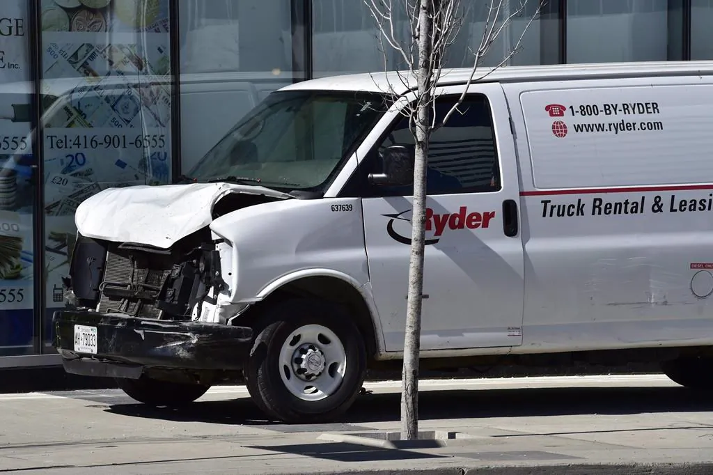 A van with a damaged front-end is shown on a sidewalk after a van mounted a sidewalk crashing into a number of pedestrians in Toronto, on April 23, 2018. (The Canadian Press/Frank Gunn)