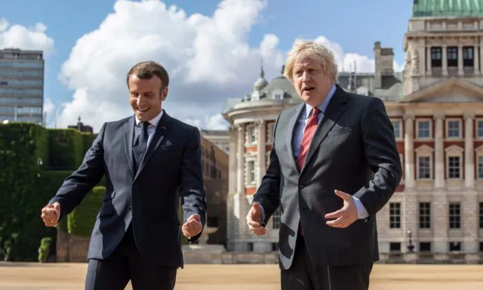 Britain's Prime Minister Boris Johnson (R) and French President Emmanuel Macron (L) on Horse Guards Parade in London, on June 18, 2020, to watch a flypast during a visit to mark the anniversary of former French president Charles de Gaulle's appeal to French people to resist the Nazi occupation during World War II. (Jack Hill/Pool/AFP via Getty Images)