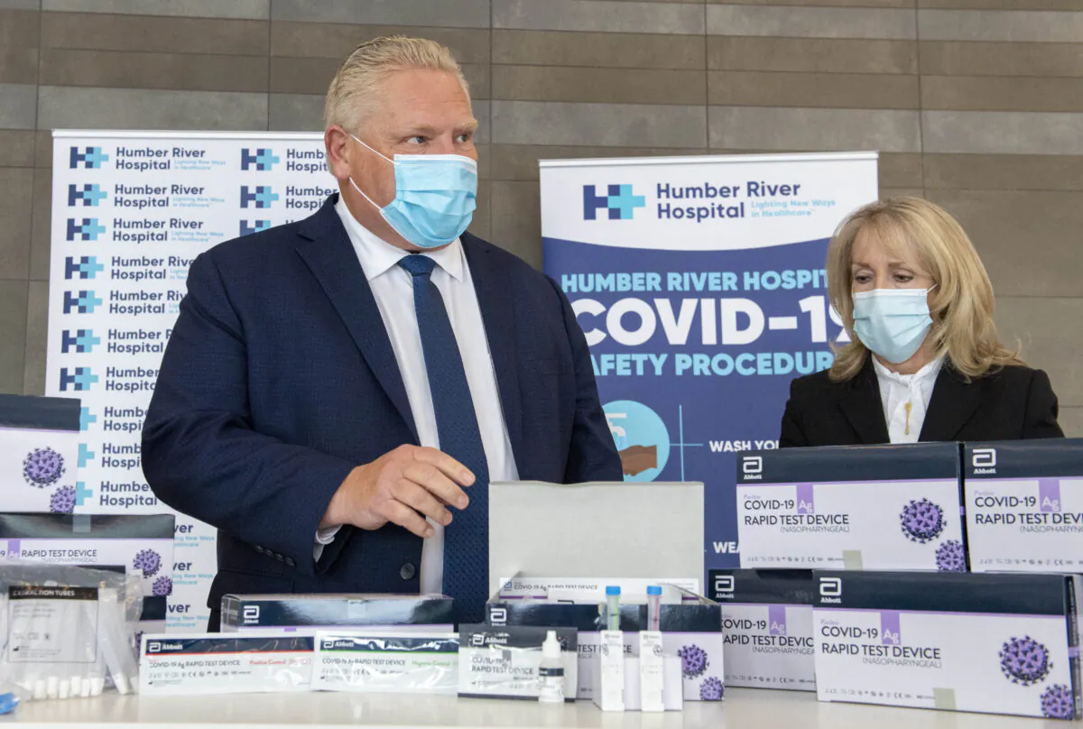 Ontario Premier Doug Ford and Long-Term Care Minister Merrilee Fullerton listen as they are briefed on COVID-19 Rapid Test Device kits at Humber River Hospital in Toronto, on Nov. 24, 2020. (Frank Gunn/The Canadian Press)
