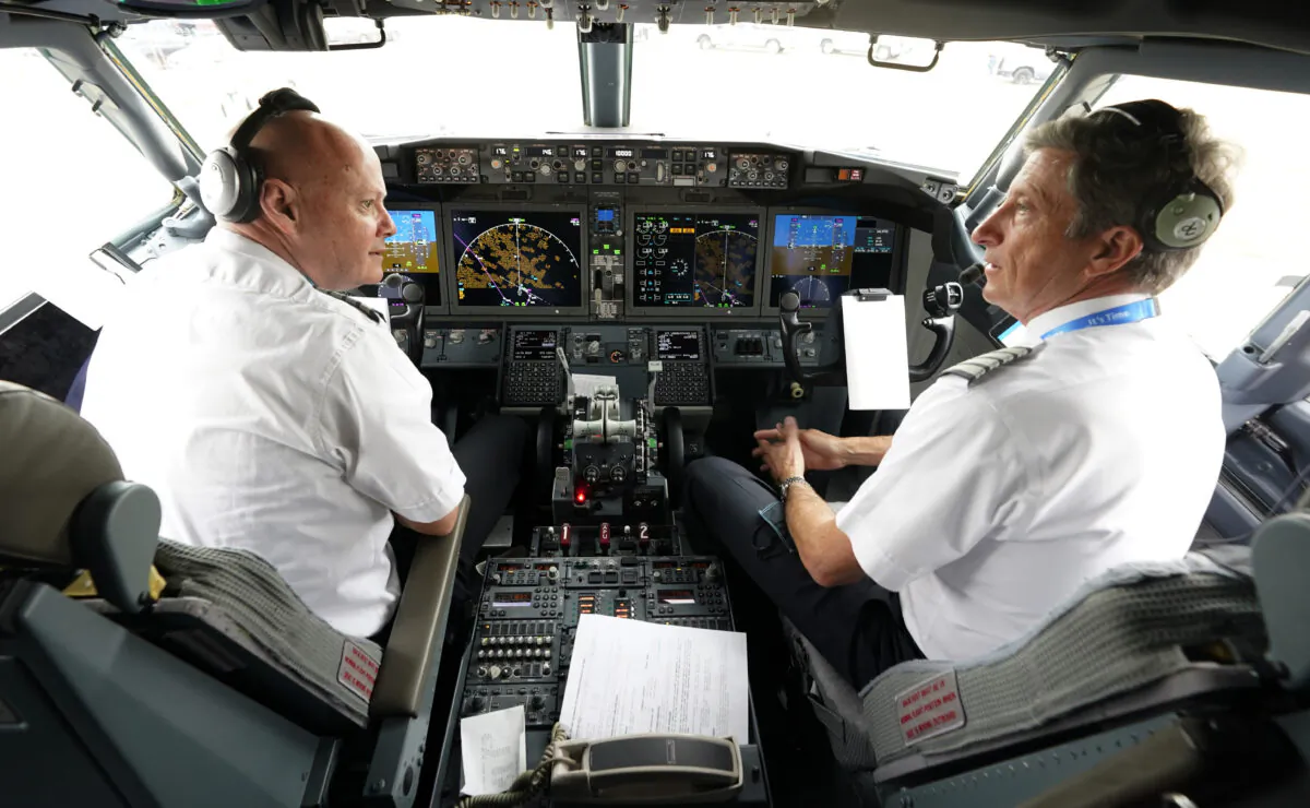 American Airlines pilots captain Pete Gamble (L), and first officer John Konstanzer chat in the cockpit of a Boeing 737 Max jet before taking off from Dallas Fort Worth airport in Grapevine, Texas, on Dec. 2, 2020. (LM Otero/AP Photo)