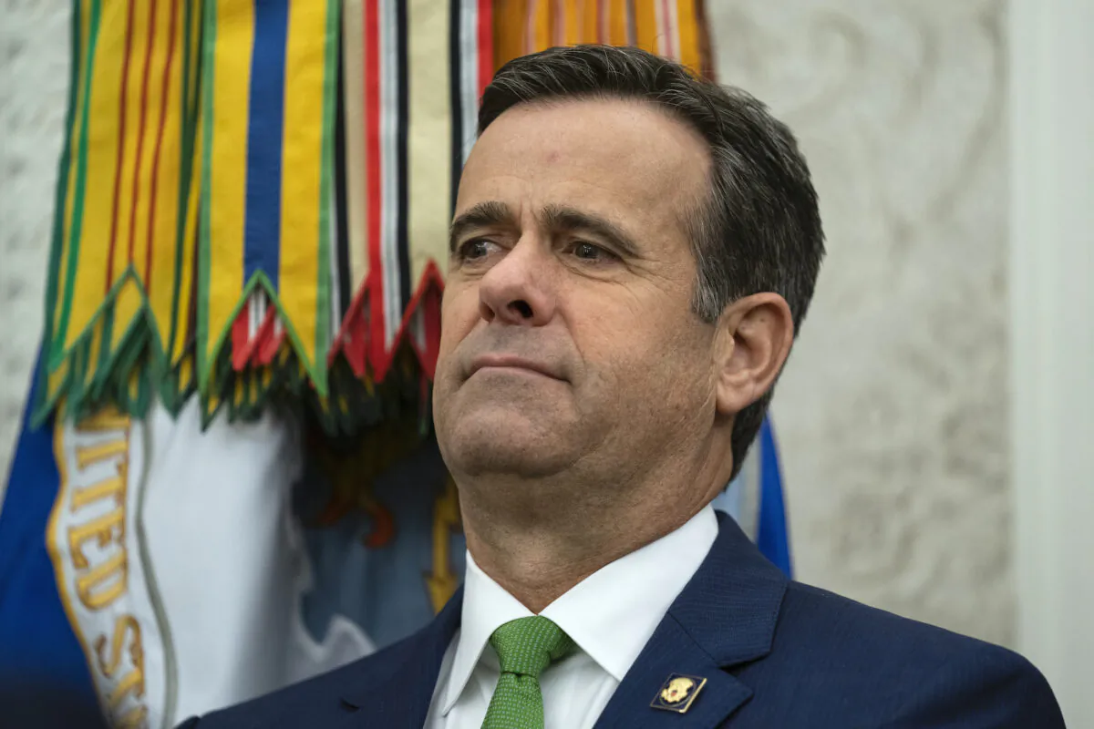 Director of National Intelligence John Ratcliffe looks on as President Donald Trump presents the Presidential Medal of Freedom to former football coach Lou Holtz, in the White House, on Dec. 3, 2020. (Evan Vucci/AP Photo)