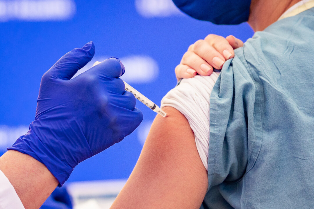 A health care worker at St. Joseph Hospital receives one of Orange County's first COVID-19 vaccine injections in Orange, Calif., on Dec. 16, 2020. (John Fredricks/The Epoch Times)