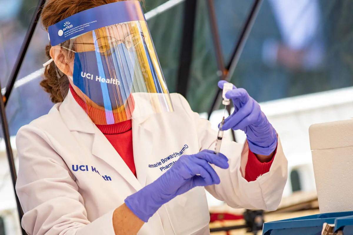 A University of California–Irvine health care worker prepares a COVID-19 vaccine in Orange, Calif., on Dec. 16, 2020. (John Fredricks/The Epoch Times)