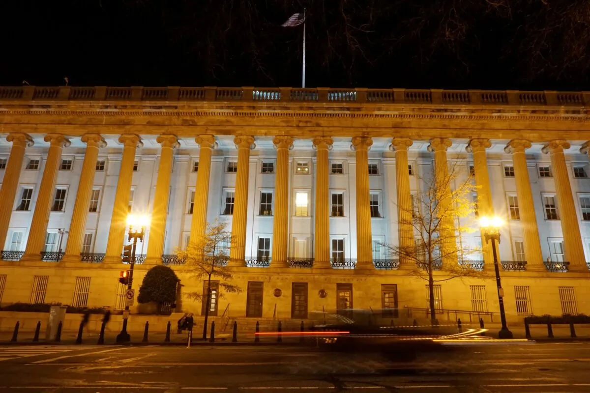 A vehicle drives past the U.S. Treasury Department in Washington, on Dec. 13, 2020. (Raphael Satter/Reuters)