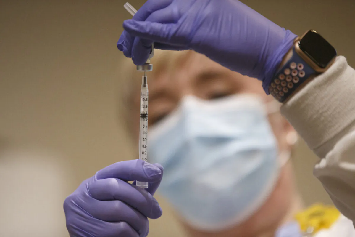 A nurse prepares the first locally-available dose of the Pfizer-BioNTech COVID-19 vaccine at Mary Washington Hospital in Fredericksburg, Va., on Dec. 15, 2020. (Mike Morones/The Free Lance-Star via AP)