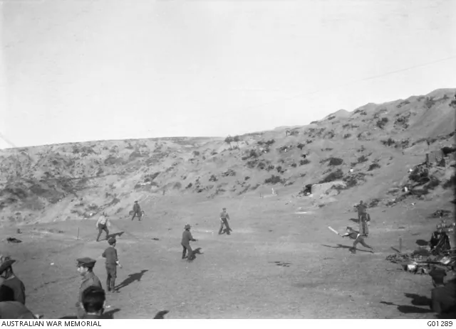 A game of cricket was played on Shell Green in an attempt to distract the Turks from the imminent departure of allied troops. Major George Macarthur Onslow of the Light Horse in batting, is being caught out. Shells were passing overhead all the time the game was in progress. (Australian War Memorial)