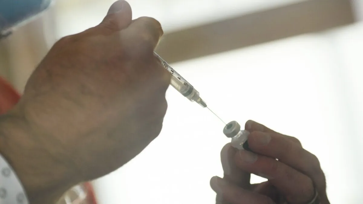 A syringe is filled from a vial of the Pfizer-BioNTech COVID-19 vaccine as it is prepared to be administered to front-line health care workers under an emergency use authorization at a drive up vaccination site from Renown Health in Reno, Nev. on Dec. 17, 2020. (Patrick T. Fallon/AFP via Getty Images)