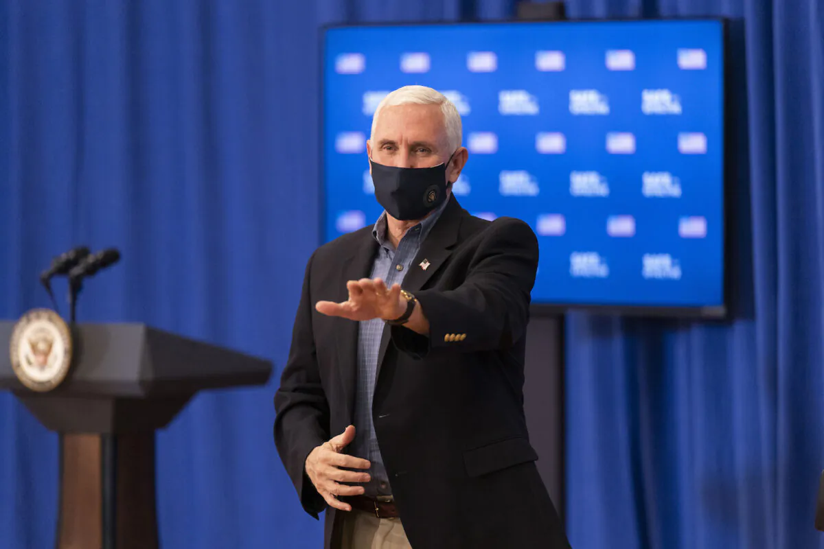 Vice President Mike Pence waves to medical staff as he leaves after getting a Pfizer-BioNTech COVID-19 vaccine shot at the Eisenhower Executive Office Building on the White House complex on Dec. 18, 2020, in Washington. (Andrew Harnik/AP Photo)