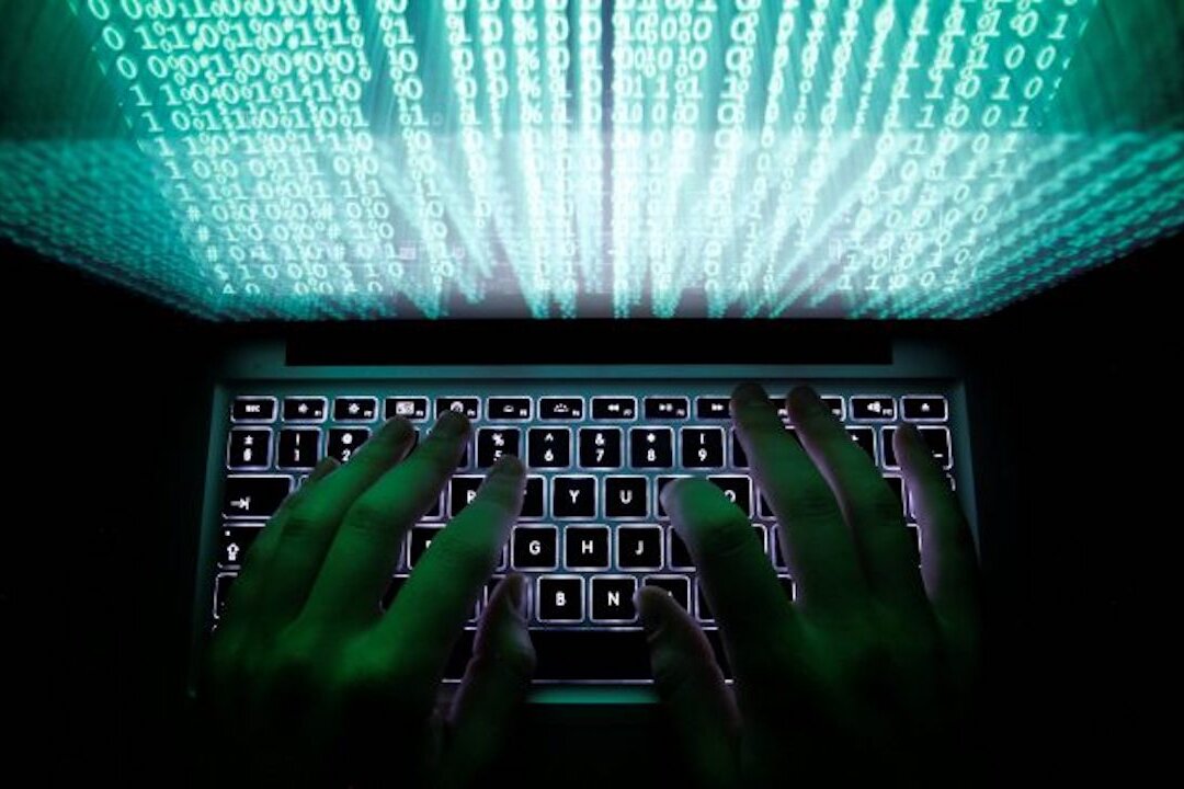 A man types on a computer keyboard. (Kacper Pempel/Reuters)