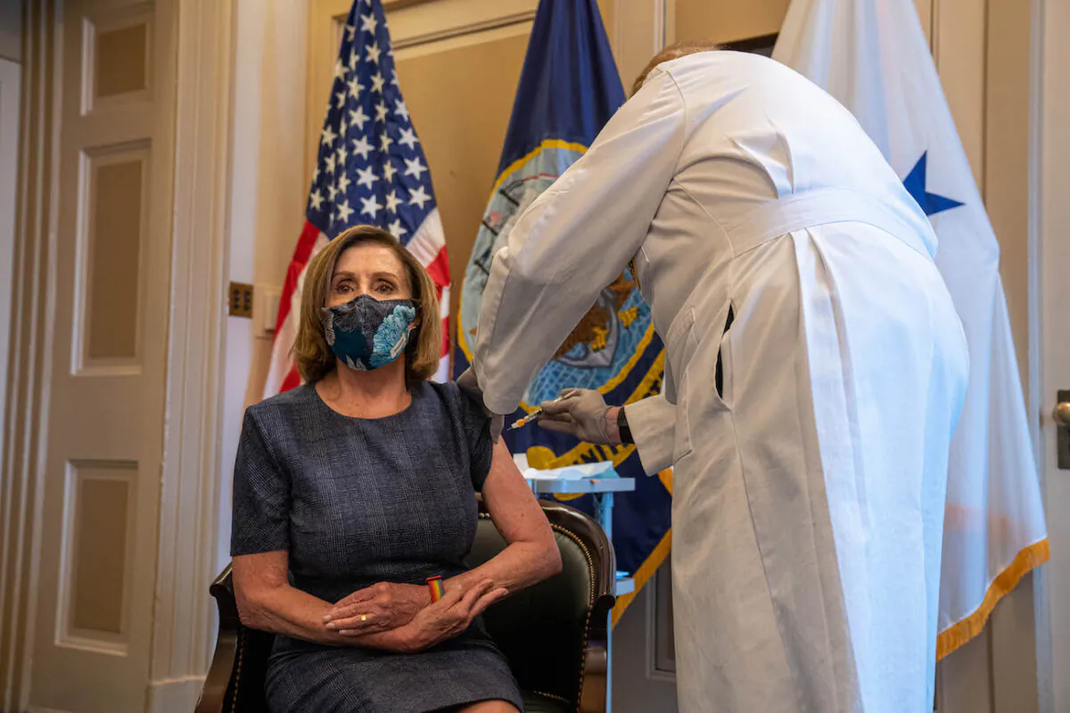 Speaker of the House Nancy Pelosi (D-Calif) receives a COVID-19 vaccination shot by Dr. Brian Monahan, attending physician of the Congress of the United States, in her office on Capitol Hill in Washington, on Dec. 18, 2020. (Ken Cedeno-Pool/Getty Images)