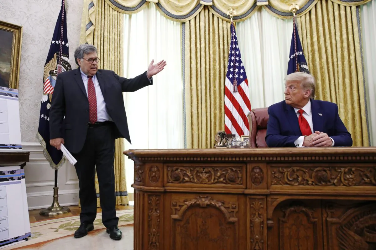 Then-Attorney General William Barr (L) speaks with then-President Donald Trump during briefing in the Oval Office of the White House in a file photo. (Patrick Semansky/AP Photo)