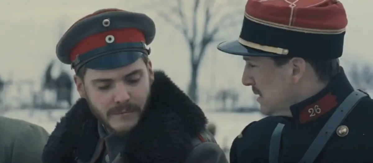 German Lt. Horstmayer (Daniel Brühl, L) and French Lt. Audebert find a good deal to bond over despite their fighting on opposite sides during World War I, in “Joyeux Noël.” (Sony Pictures Classics)