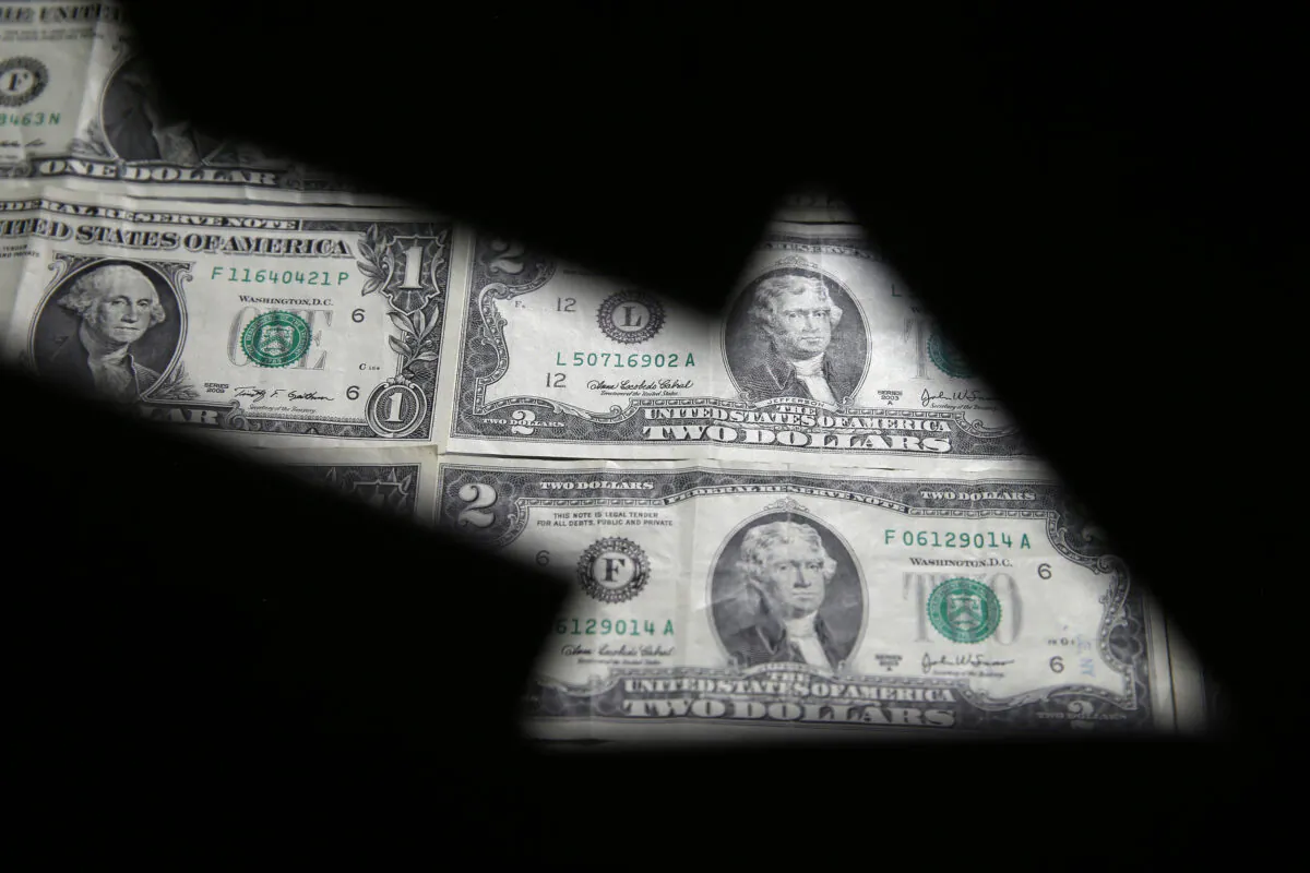 U.S. dollar banknotes are seen through a printed stock graph in this illustration taken on Feb. 7, 2018. (Dado Ruvic/Reuters)