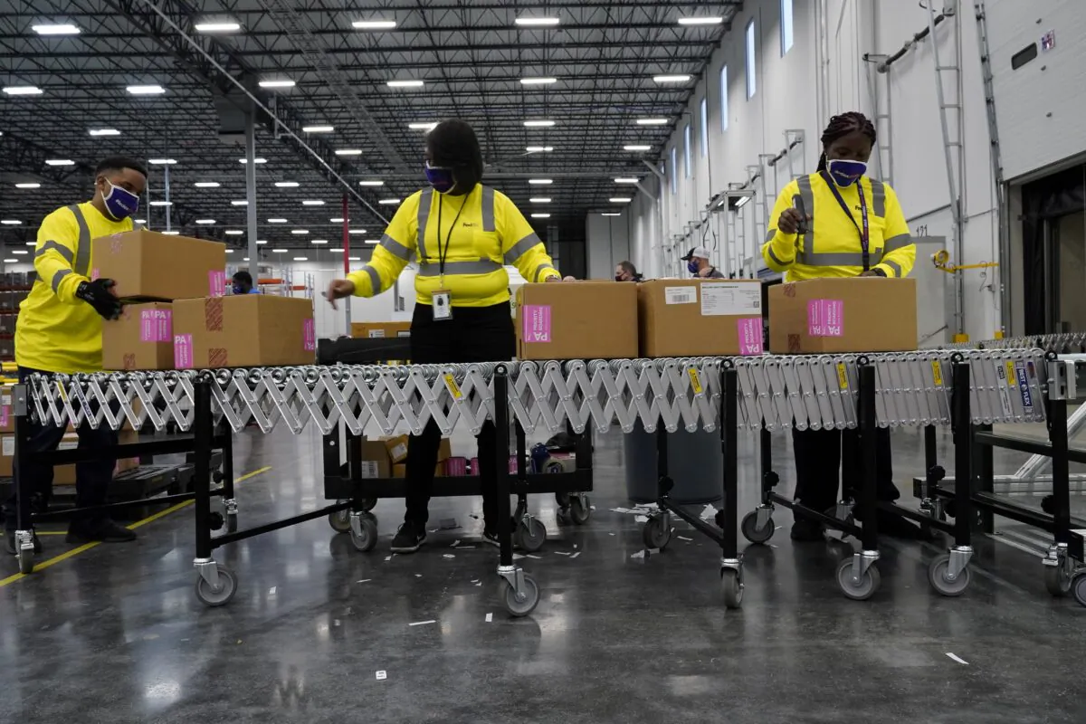 Boxes containing the Moderna COVID-19 vaccine are prepared to be shipped at the McKesson distribution center in Olive Branch, Miss., on Dec. 20, 2020. (Paul Sancya/Pool via Reuters)