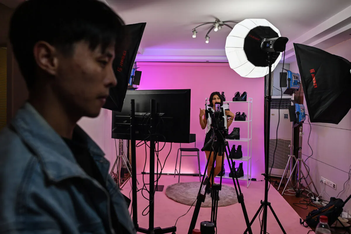 Silvia Rivera (in background) attending a livestreaming event from a studio in Shanghai to offer products on an Aliexpress channel in Spain, on October 23, 2020. (HECTOR RETAMAL/AFP via Getty Images)