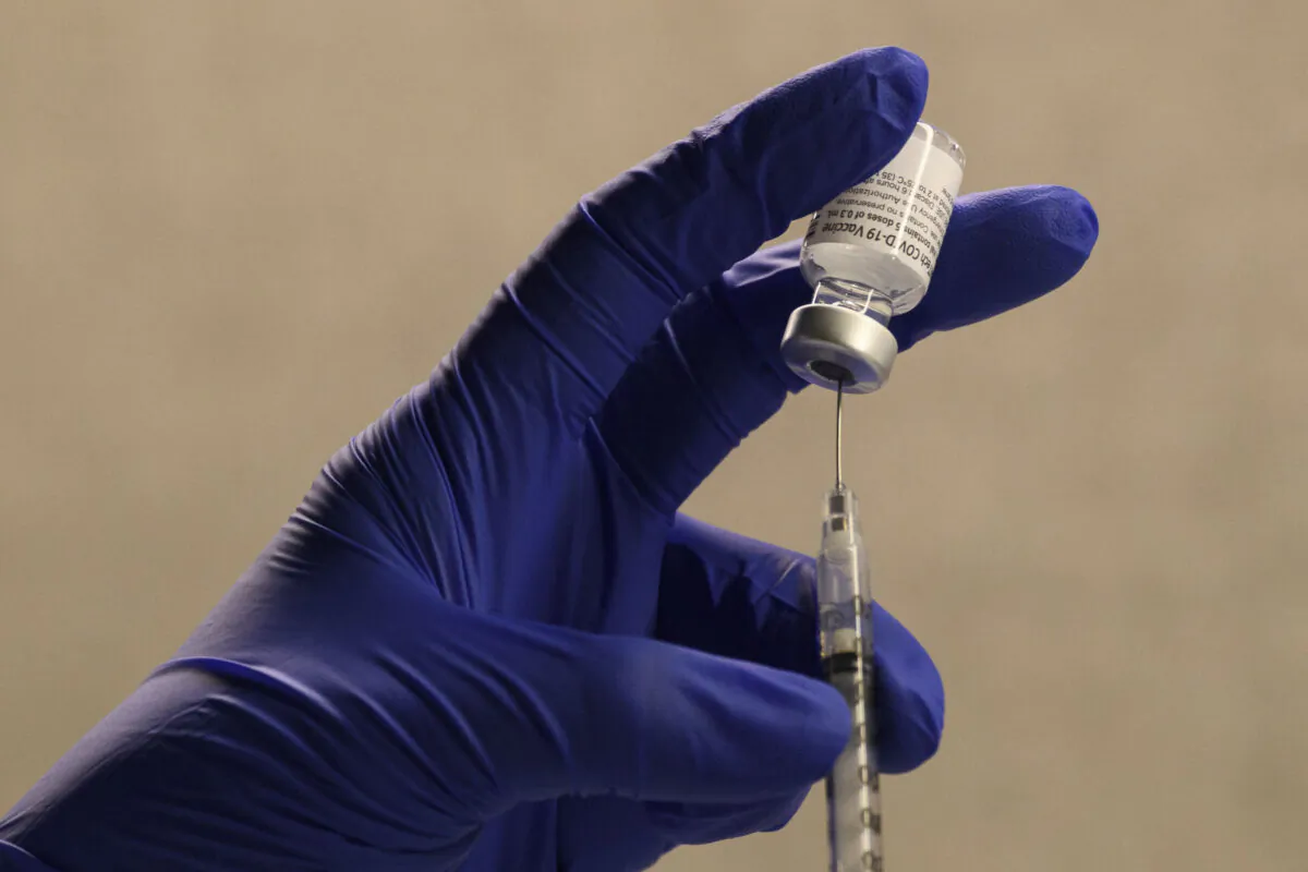 A pharmacist fills a syringe to prepare a dose of the Pfizer-BioNTech COVID-19 vaccine at a vaccination site at Torrance Memorial Medical Center in Torrance, Calif., on Dec. 19, 2020. (Patrick Fallon/AFP via Getty Images)