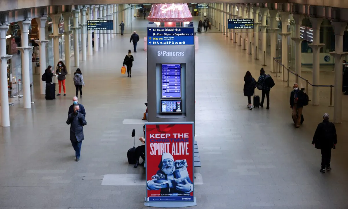 Travellers walk through the St. Pancras International train station in London in the U.K. on Dec. 21, 2020, as EU countries impose a travel ban from the U.K. following the COVID-19 outbreak. (Hannah McKay/Reuters)