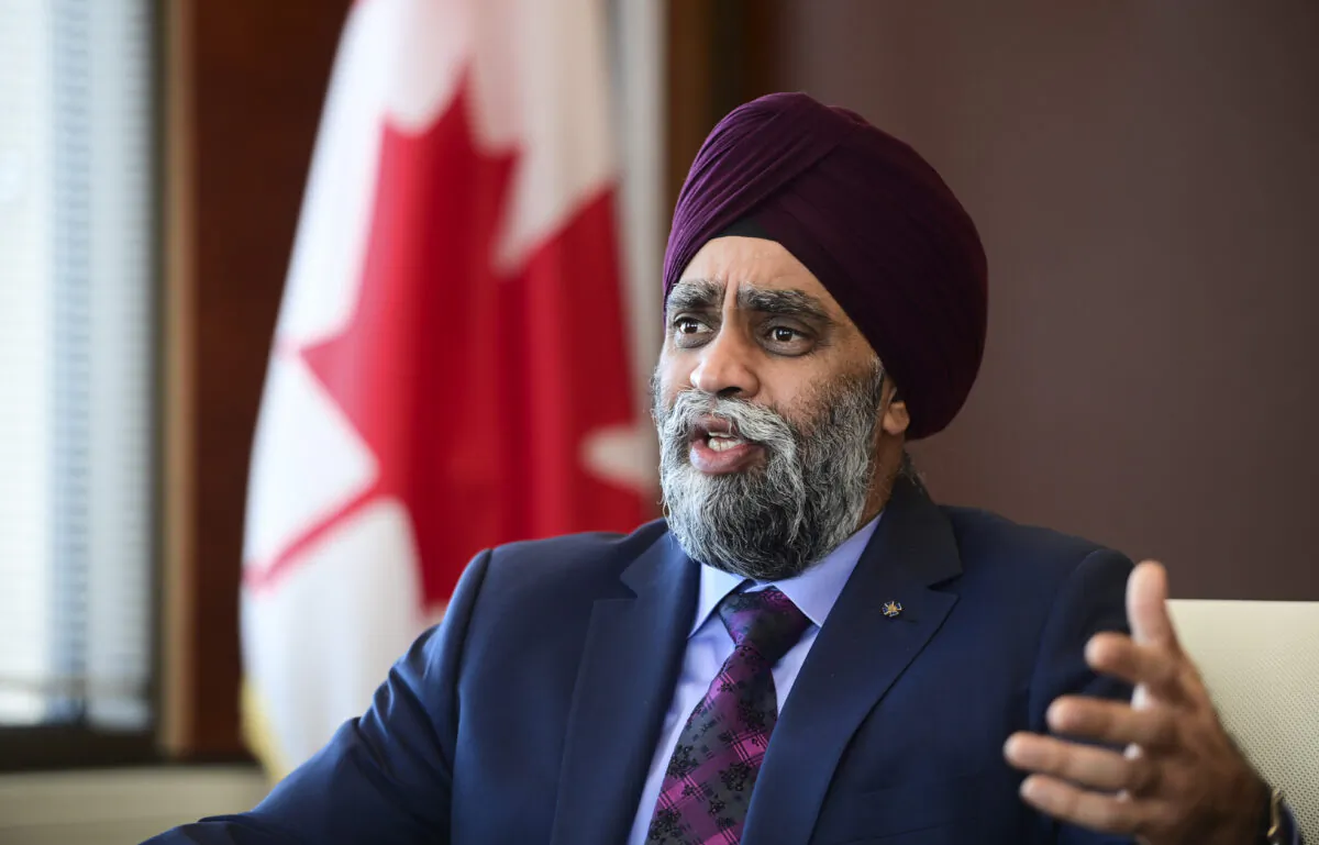 Minister of National Defence Harjit Sajjan speaks to a reporter at National Defence Headquarters in Ottawa on Dec. 17, 2020. (Sean Kilpatrick/The Canadian Press)
