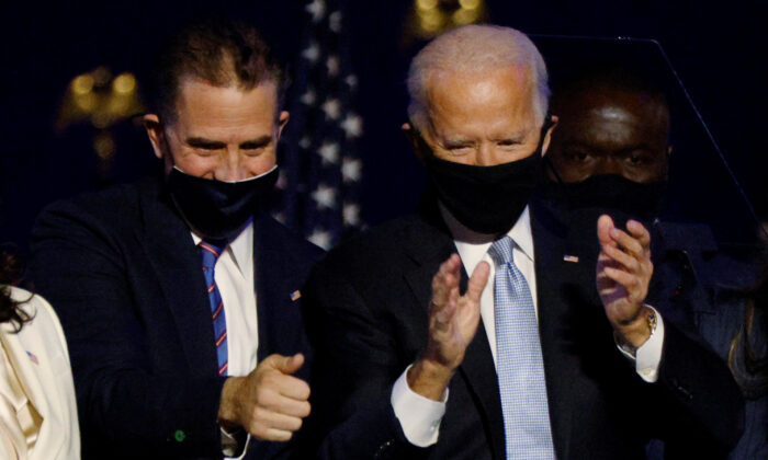 Hunter Biden, left, and Joe Biden celebrate during a rally in Wilmington, Del., on Nov. 7, 2020. (Jim Bourg/Reuters)