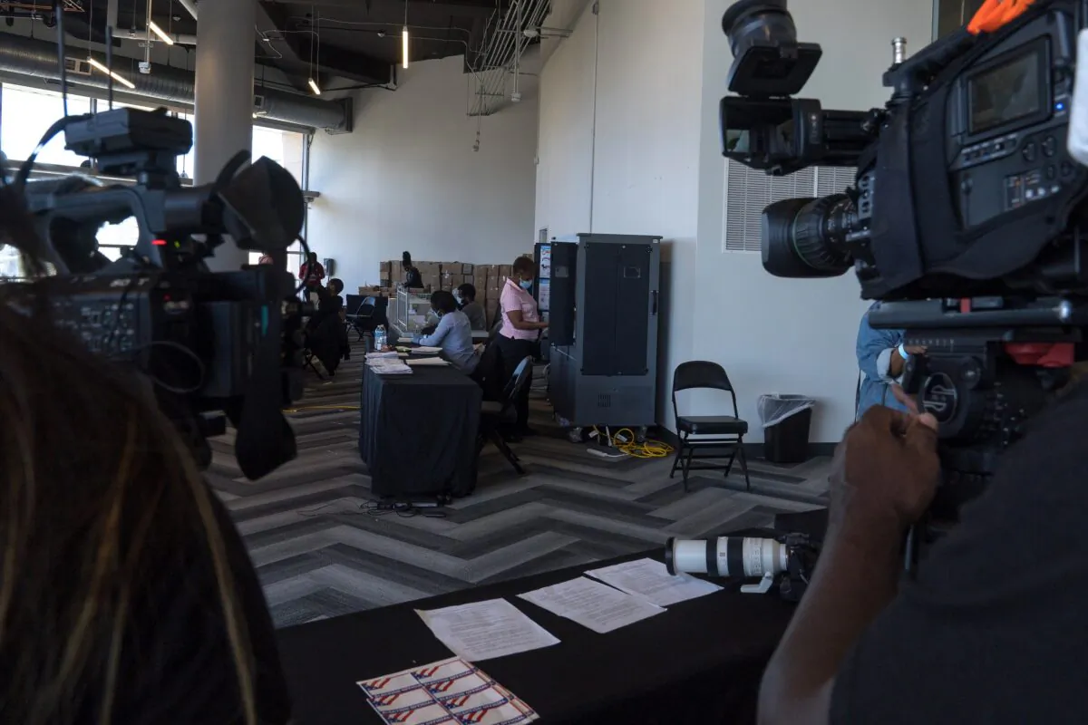 Media crews film while election workers process absentee ballots at State Farm Arena in Atlanta on Nov. 2, 2020. (Megan Varner/Getty Images)
