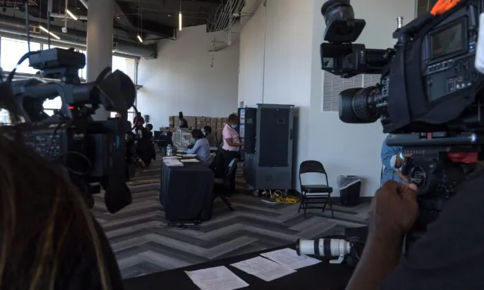 Media crews film while election workers process absentee ballots at State Farm Arena in Atlanta on Nov. 2, 2020. (Megan Varner/Getty Images)